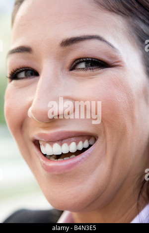 Woman's smiling face outdoors (selective focus) Stock Photo