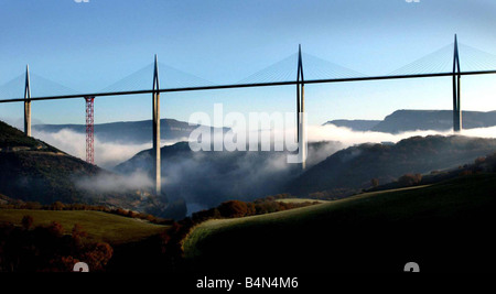 The biggest bridge in the world the Millau Viaduct The bridge designed by Norman Foster rises above the cloudbase clouds scenic Stock Photo