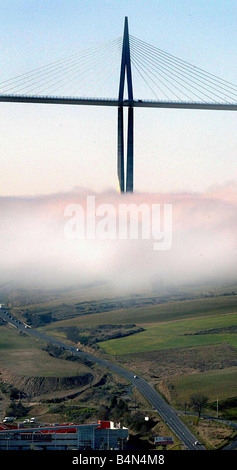 The biggest bridge in the world the Millau Viaduct The bridge designed by Norman Foster rises above the cloudbase clouds scenic Stock Photo