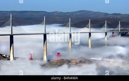 The biggest bridge in the world the Millau Viaduct The bridge designed by Norman Foster rises above the cloudbase clouds scenic Stock Photo