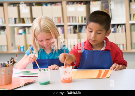 Two students in art class painting Stock Photo