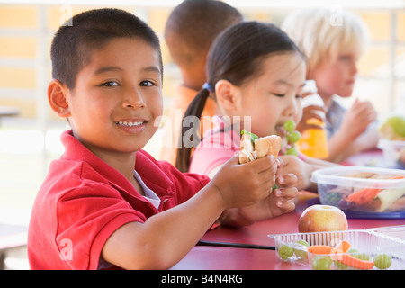 Students outdoors eating lunch (selective focus) Stock Photo