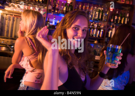 Young woman in a bar with friends Stock Photo
