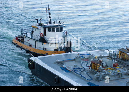 Tug boat pushes fuel barge into position to refuel cruise ship Stock ...