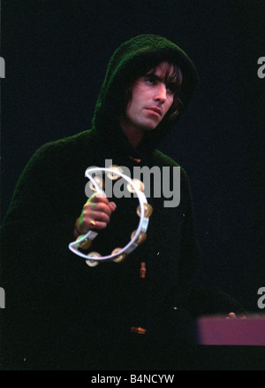 Liam Gallagher playing the tambourine during the Oasis concert at Stock ...