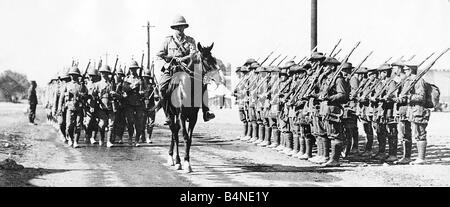 Troops from a Lancashire Regiment led by their commanding officer on horseback pass an Australian guard at Abassia near Cairo in Egypt World War One 1915 Stock Photo