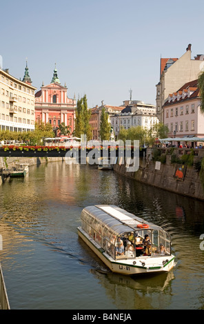 Sightseeing boat sails down Ljubljanca river trough Ljubljana city the capital of Slovenia Europe Stock Photo