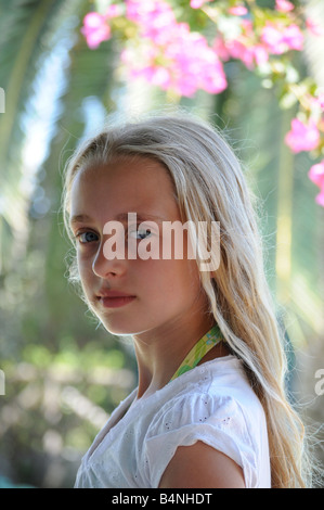 Royalty free photograph of young girl with fair light skin on summer holiday with pretty smile and blonde hair looking happy Stock Photo