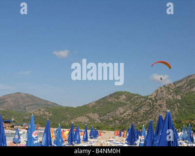 paraglider coming in to land over beach at Olu Deniz, Turkey Stock Photo