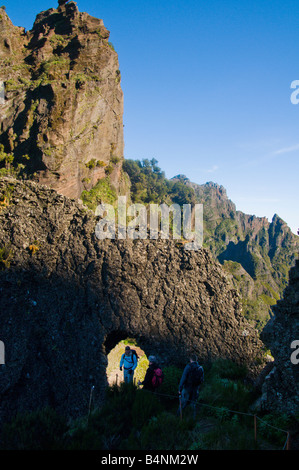 Walkers and rock arch on Pico das Torres Madeira Stock Photo