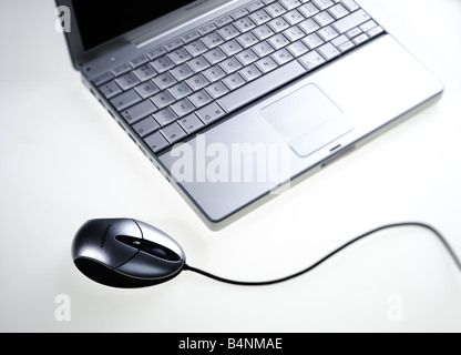 Detail of silver Apple Mac laptop computer keyboard and mouse on white background Stock Photo