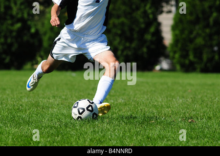 Football or soccer footwork from players at a high school or U18 or U17 level of play Stock Photo