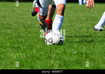 Football or soccer footwork from players at a high school or U18 or U17 level of play Stock Photo