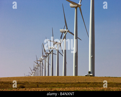 A technician attends to a power generating windmill farm near Zaragoza Spain Stock Photo