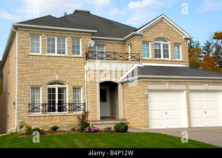 New detached single family luxury home with stone facade and double garage Stock Photo