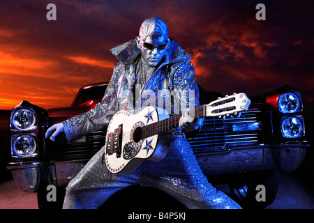 License and prints at MaximImages.com - Silver Elvis with a guitar and a classic retro american car Stock Photo