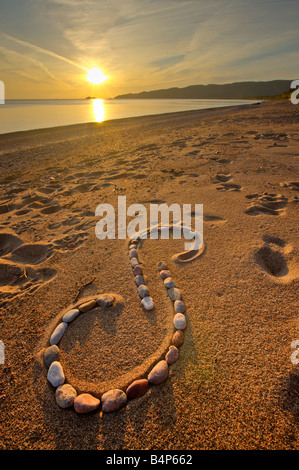 Rock design along the beach in Agawa Bay at sunset, Lake Superior, Lake Superior Provincial Park, Ontario, Canada. Stock Photo