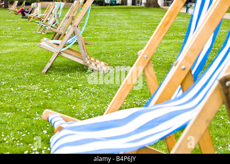 Empty deck chairs at St Jame s London Park Focus on the second pair of chairs Stock Photo