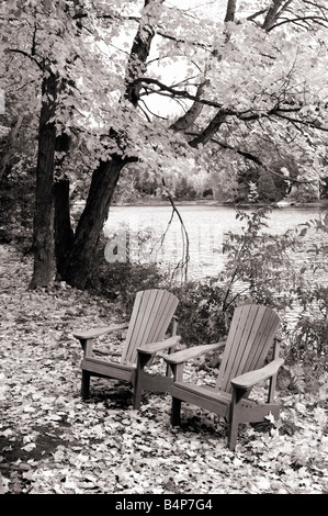 Two empty chairs near a lake Stock Photo