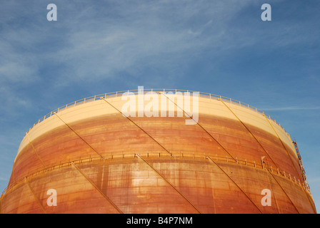 Giant rusting steel gasholder against blue sky Suitable for use as background image Stock Photo