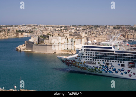 Mediterranean travel and tourism. The cruise liner Norwegian Gem departing from Malta's Grand Harbour, with Fort St Angelo in the background Stock Photo