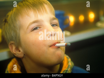 Small boy smoking a cigarette Stock Photo