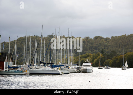 stormy clouds gather over the boats and yachts moored on lake windermere Stock Photo