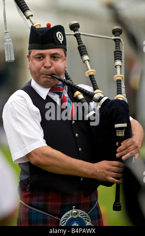 Piper at the Cowal Gathering in Dunoon in Scotland. The Gathering is a traditional Highland Games held each year in Dunoon Stock Photo