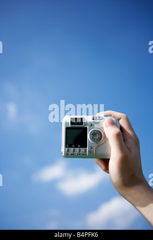 Human hand holding digital camera, close up Stock Photo