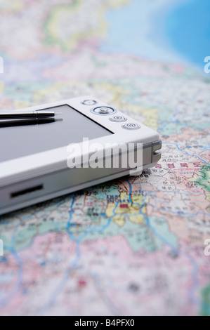 Mobile phone and stylus on world map Stock Photo