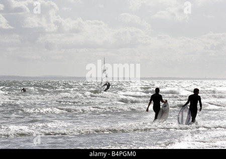 Surfers and windsurfers near West Wittering in Sussex on the South Coast of England Stock Photo