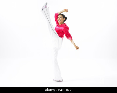 Young woman performing kick Stock Photo