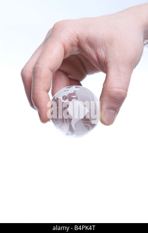 Human hand holding crystal globe Stock Photo