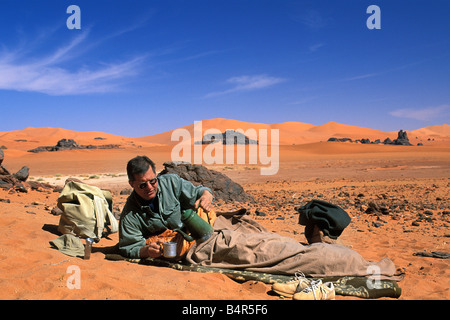 Algeria Djanet Camp Tourist having coffee Sahara Desert Stock Photo