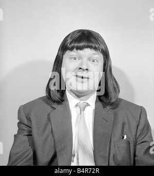 Comedian Benny Hill pictured at home wearing a wig May 1958 Stock Photo