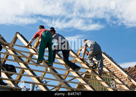 builders constructing the roof of a house Stock Photo
