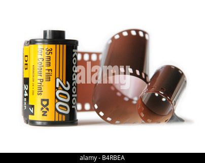 A section of 35mm film and film cassette. Stock Photo