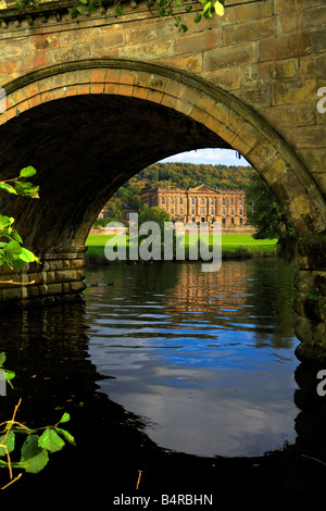 River Derwent and Chatsworth House viewed through an arch of the bridge, Derbyshire, England, UK. Stock Photo