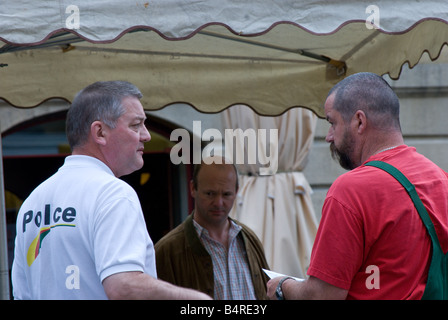 Policeman and produce vendor having a discussion Stock Photo