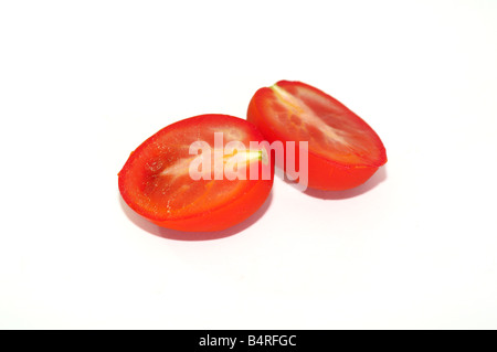 A Roma tomato cut in half on a white background. Stock Photo