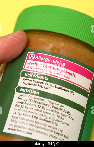 Food allergy product packaging contents label with advice warning on jar of peanut butter spread Stock Photo