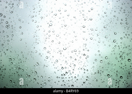 rain drops on a window and mystic silhouette of city Stock Photo