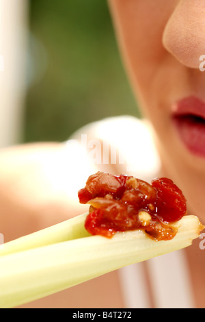 Woman Eating Celery and Salsa Model Released Stock Photo