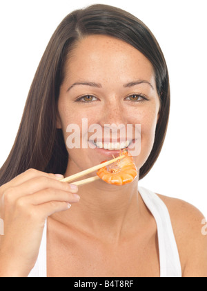 Healthy Young Woman Eating A Prawn Using Chopsticks Isolated Against A White Background With A Clipping Path Stock Photo