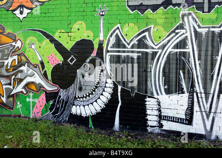 Witch graffiti on an old brick wall Halloween graffiti on the wall below a railway line art wallart community project network ra Stock Photo