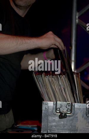 detail of side profile of DJ selecting records from his metal record box Stock Photo