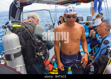 Divers preparing to go scuba diving off Sipadan Island nr Semporna Sabah Malaysia Stock Photo