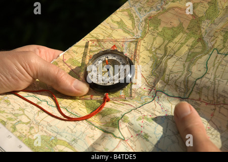 Checking Location on a Map and a Compass close up Stock Photo