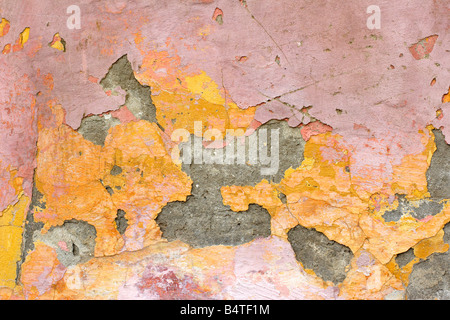 flaking plaster and paint on old wall Stock Photo