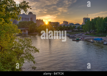 Sunset over a marina on the Assiniboine River at The Forks, a National Historic Site in the City of Winnipeg, Manitoba, Canada. Stock Photo